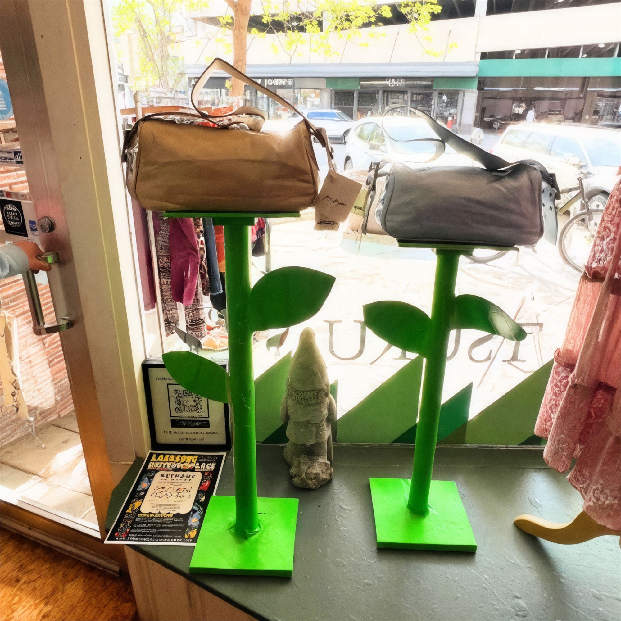 Tsuru window detail with green plant-shaped display stands holding duffel bags.