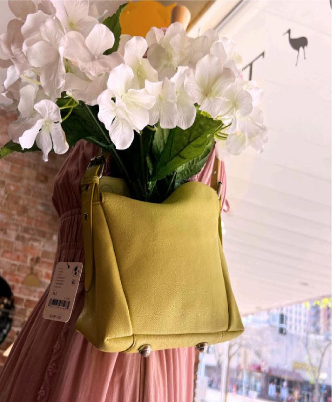Tsuru window detail: a yellow handbag holding white hydrangeas.